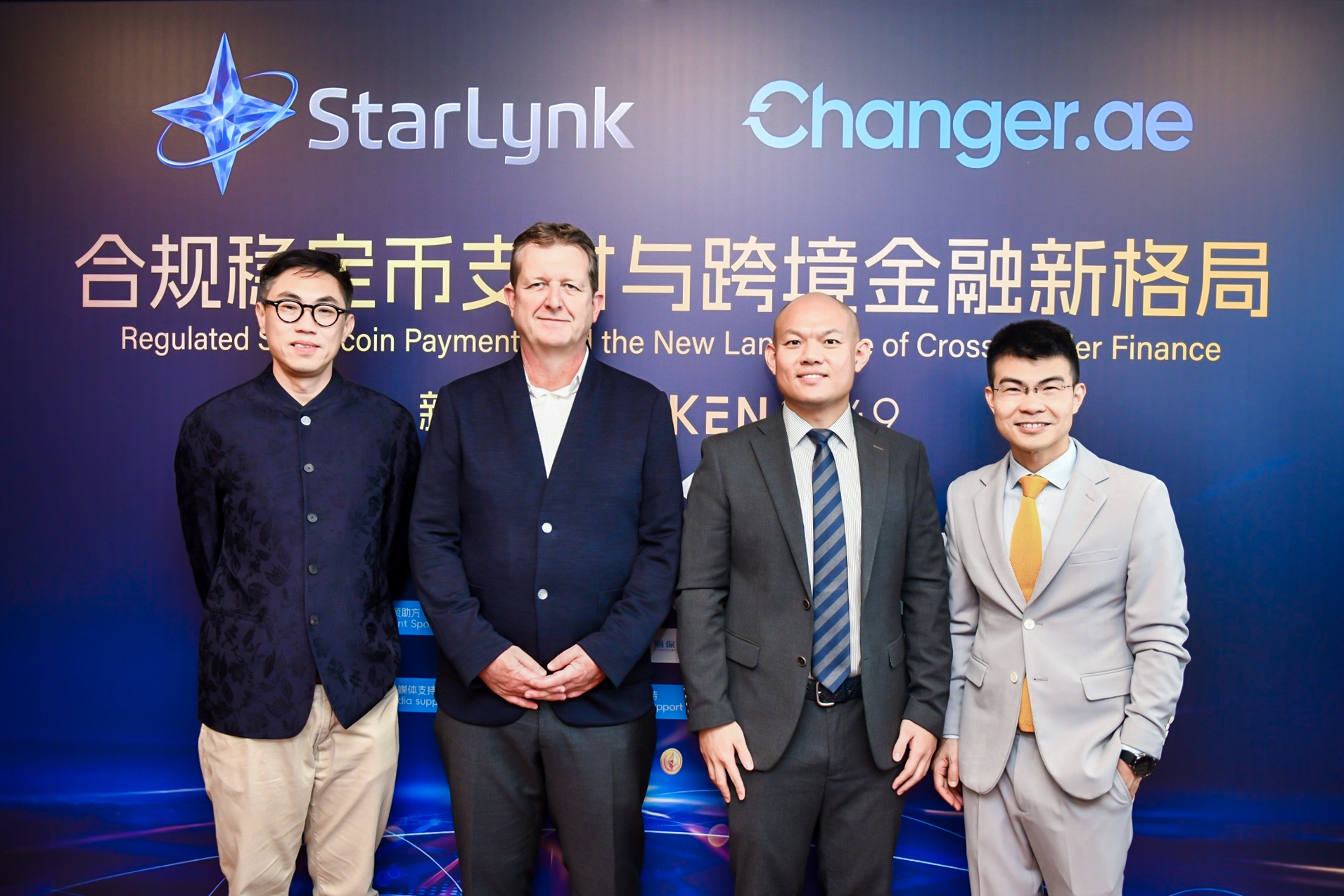 Four people at a stablecoin payments event in front of StarLynk and Changer.ae branding.